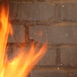 Gray brick wall focus on strong fire