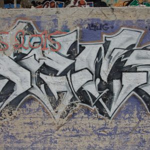 White And Blue Spray Paint Graffiti On Wall