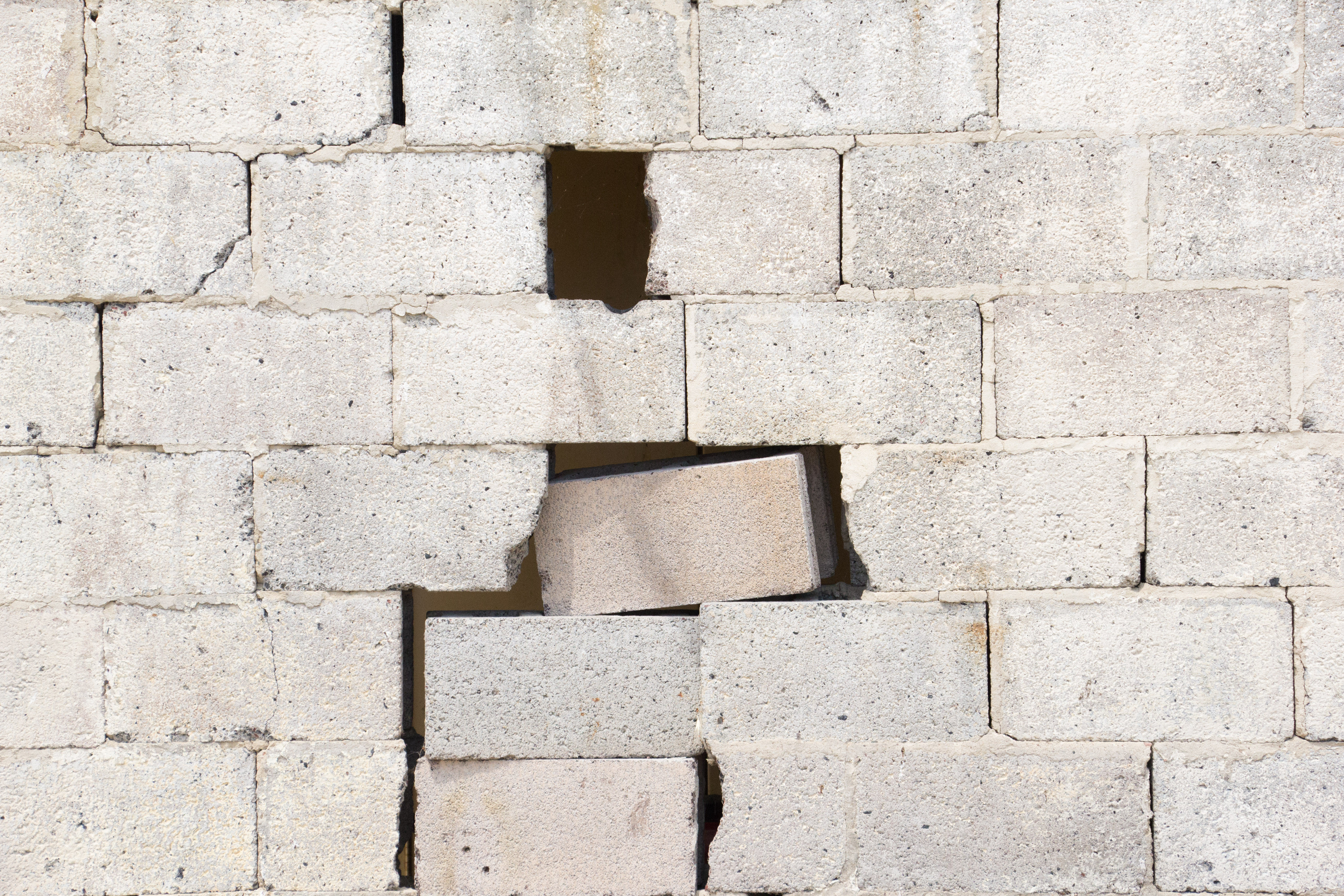 Brick White Wall Damaged From War