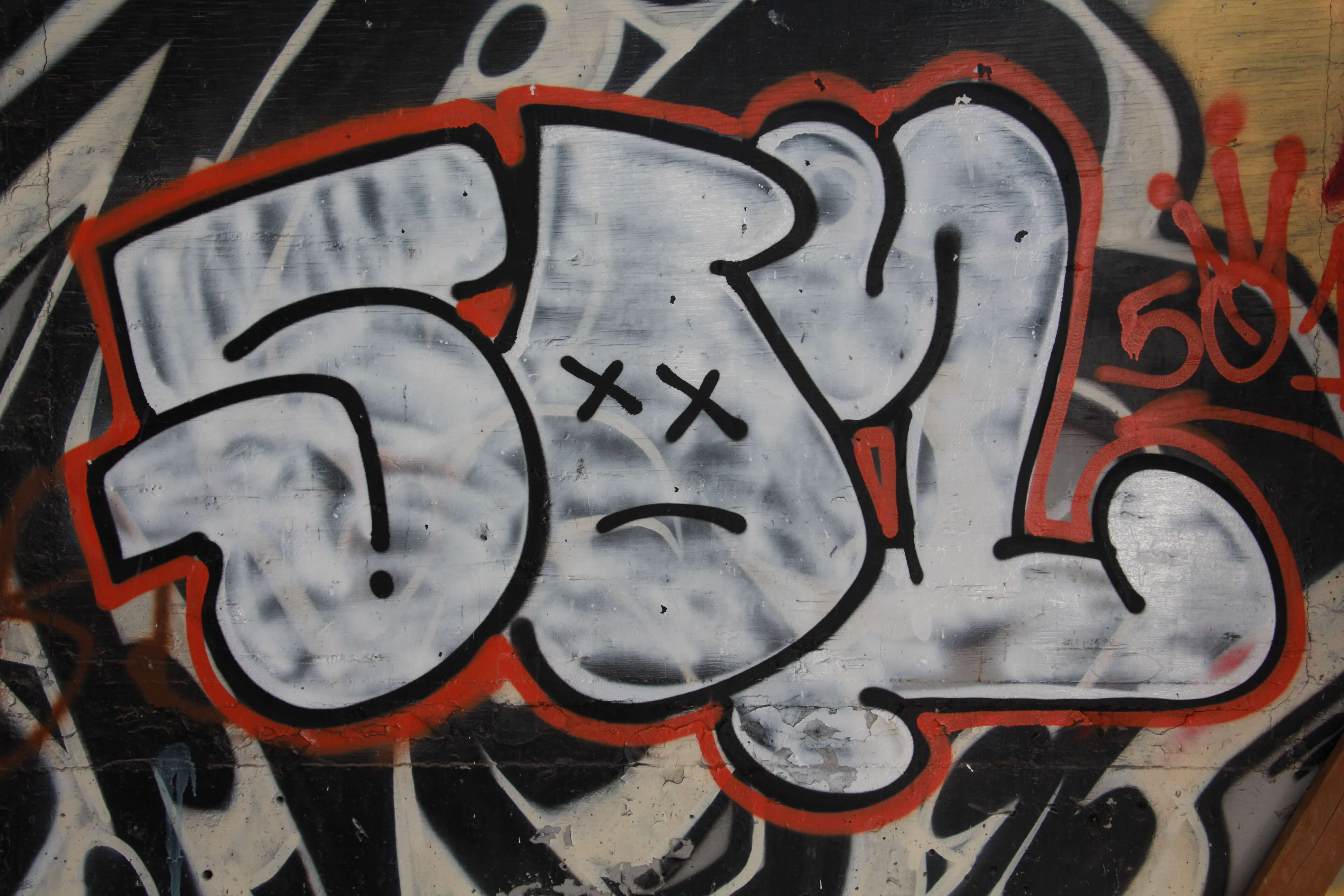 Letter Spray Painted In White Red Graffiti On Wall