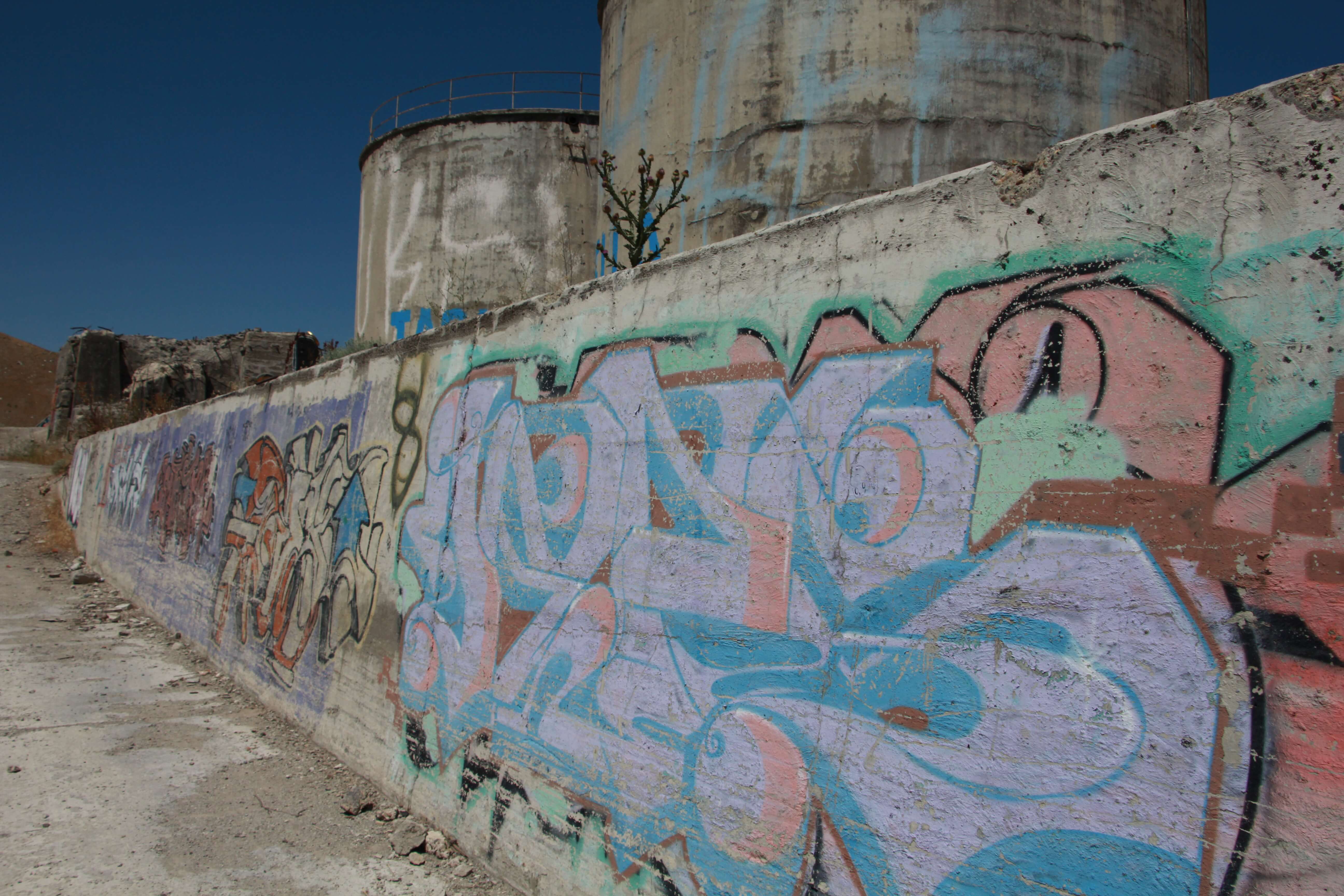 Multi Colored Spray Paint Graffiti On Long Wall