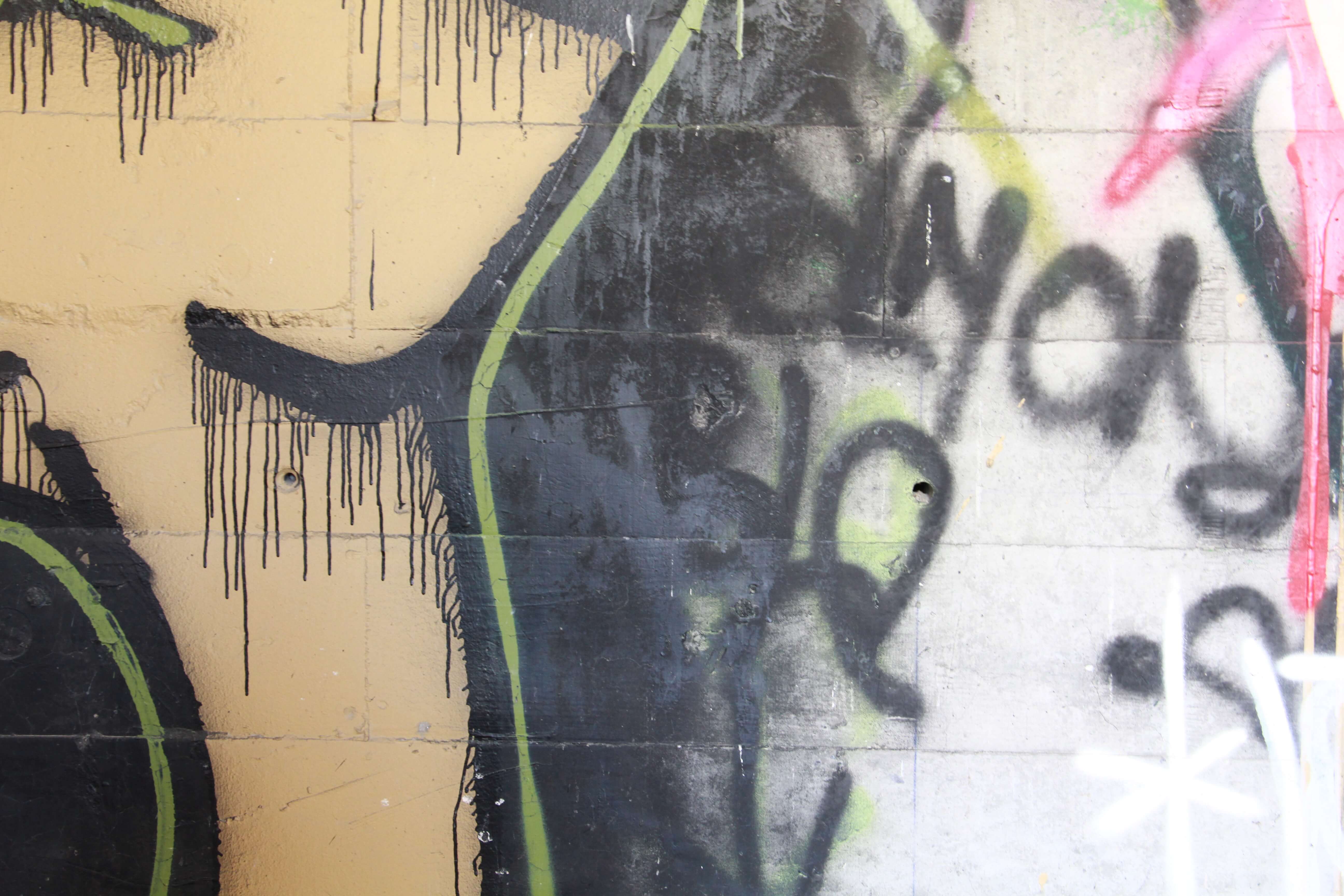 Orange White Black Spray Paint Graffiti On Brick